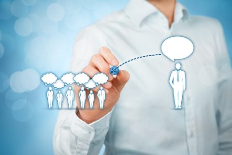 Someone showing effective communication by drawing others with thought bubbles